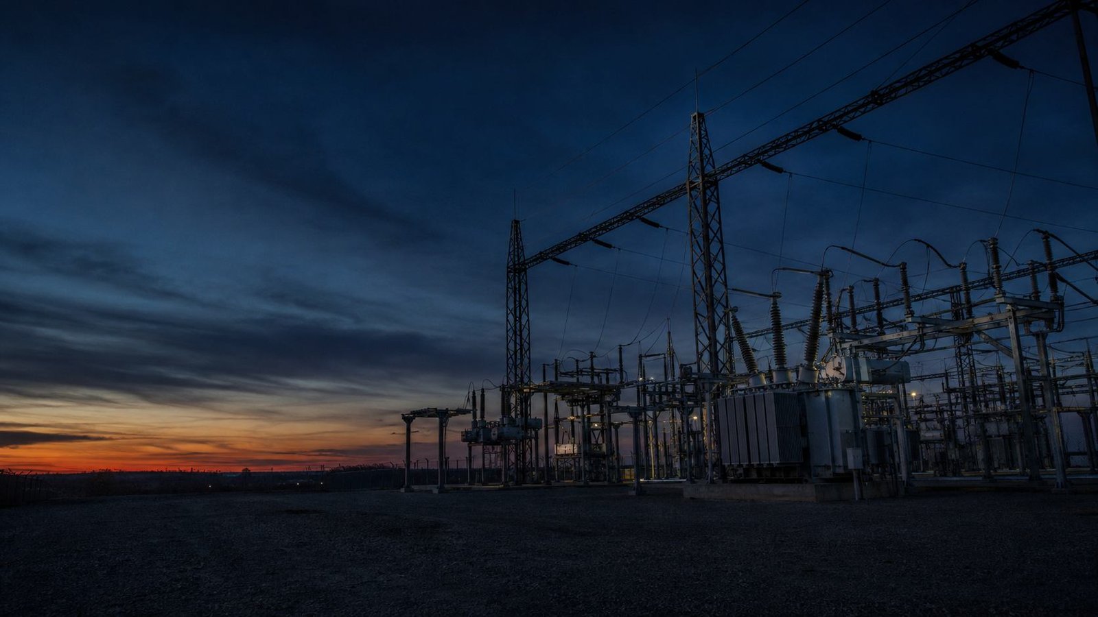 Commissioning engineers working in a high-voltage substation switchyard